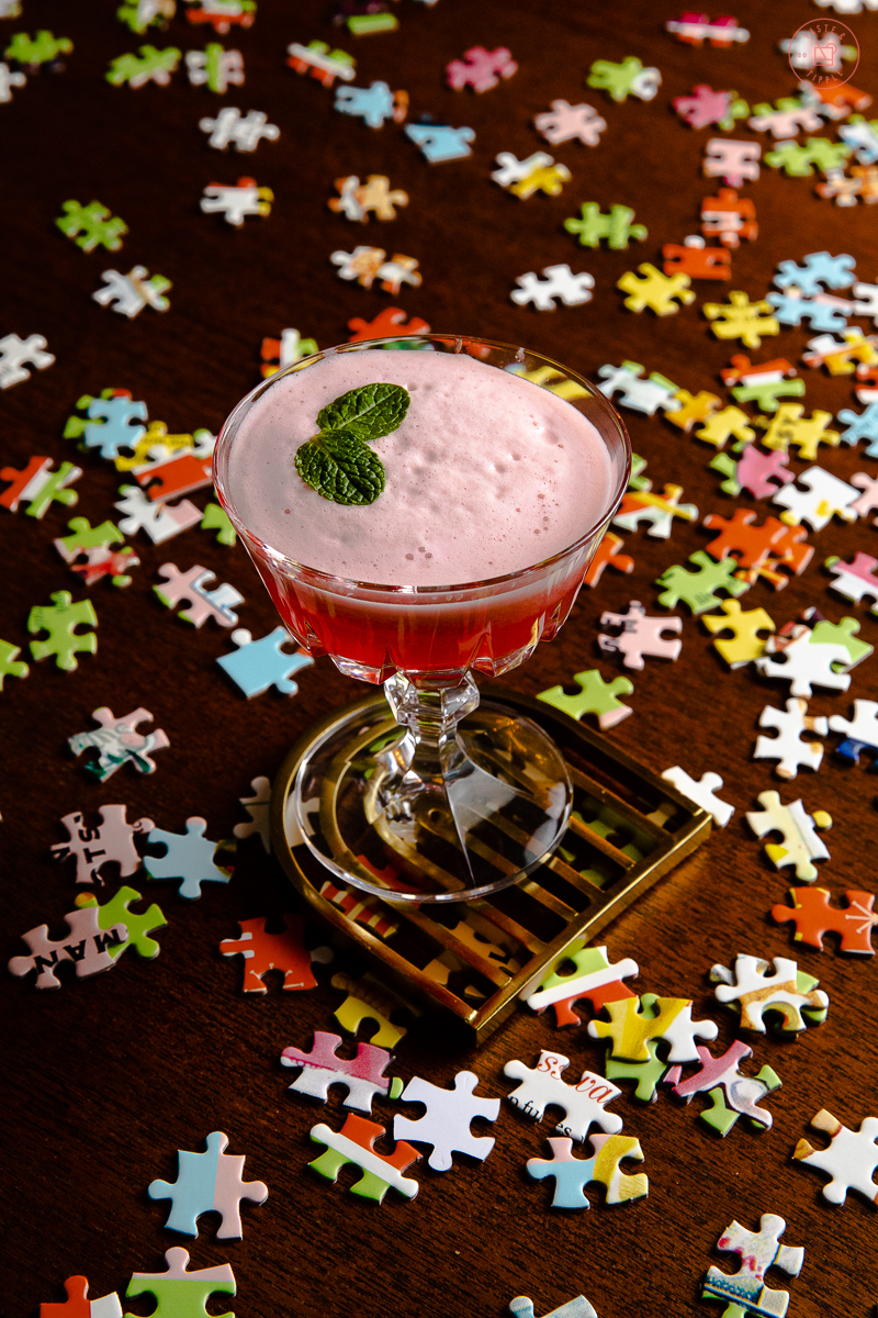Easy whisky cocktail on top of puzzle pieces.